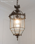 Suspension lanterne fuselée en bronze à panneaux transparents et couronne décorative, diamètre 22 cm