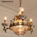 Lustre en bronze et Capodimonte à coupelles fleuries et globe central à motifs étoilés, diamètre 50 cm