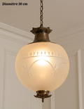 Suspension à monture en bronze et globe dépoli à motifs en arcs et étoiles, diamètre 30 cm