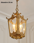 Lanterne suspendue en bronze ornée de volutes, panneaux transparents à motifs étoilés, diamètre 18 cm